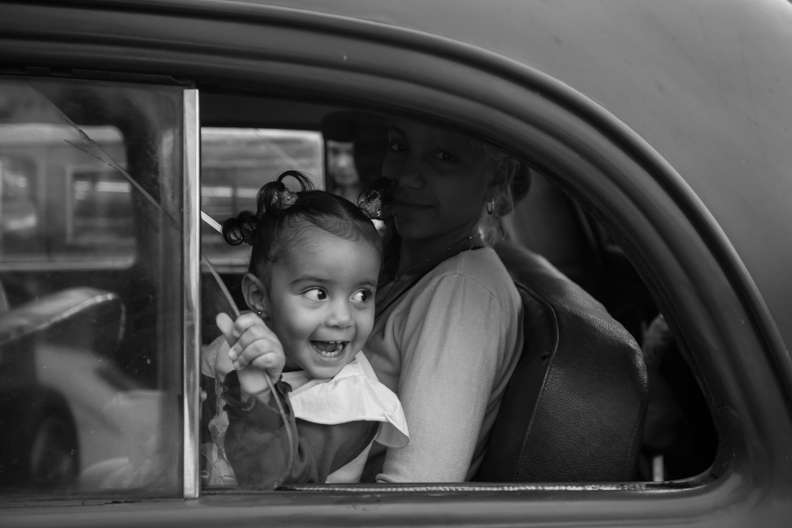 Una madre llevando a su pequeña a la escuela en un taxi compartido